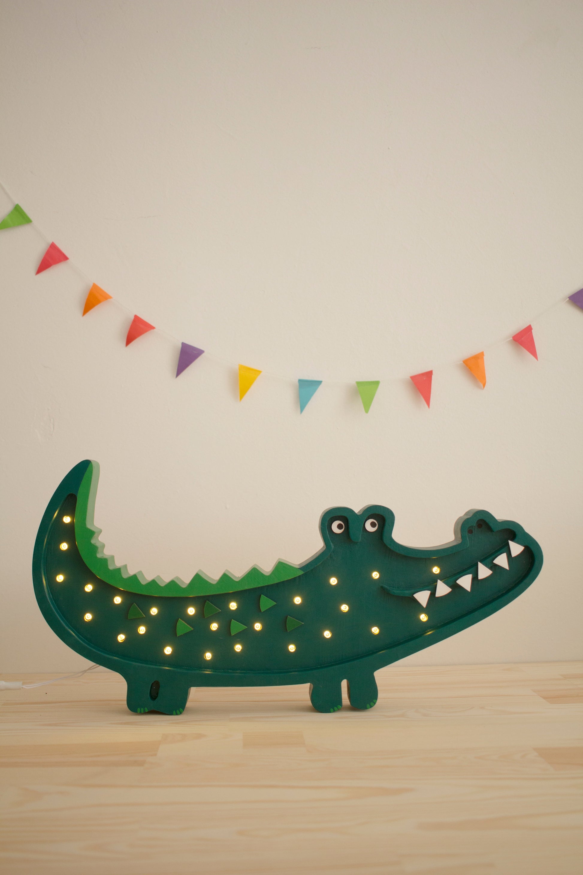 Papkin Green Crocodile Lamp adding warm glow to nursery décor
