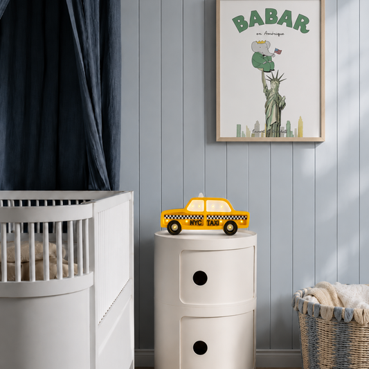 NYC Taxi Night Light in a baby boy's nursery glowing softly by the crib